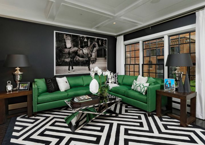 Черно-белый интерьер гостиной с зеленым диваном